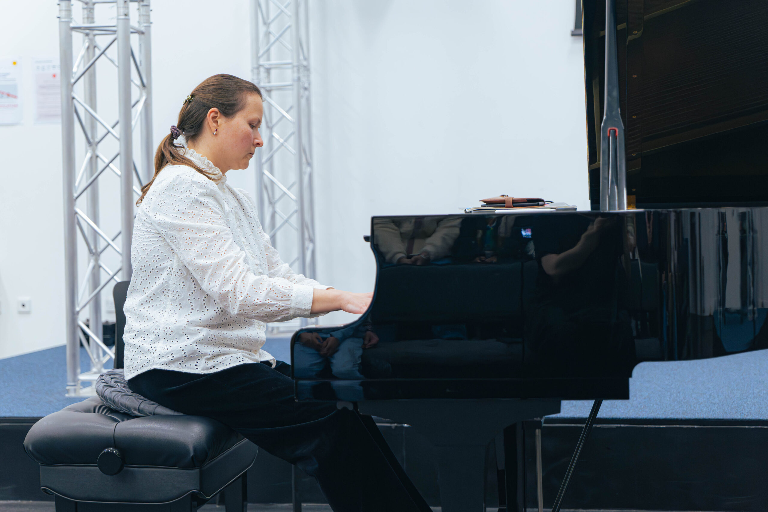 Pianist performing on a grand piano at a concert